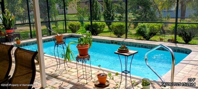 outdoor pool with a patio and glass enclosure