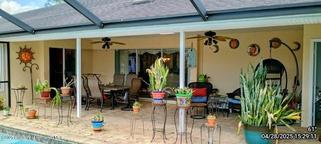 exterior space with a patio, ceiling fan, and a shingled roof