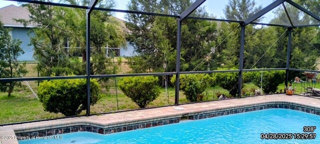 outdoor pool featuring glass enclosure