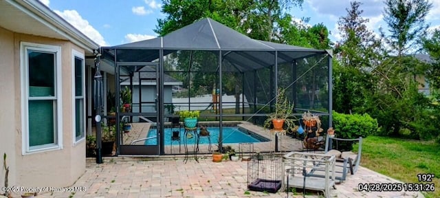 view of swimming pool featuring a fenced in pool, glass enclosure, and a patio area