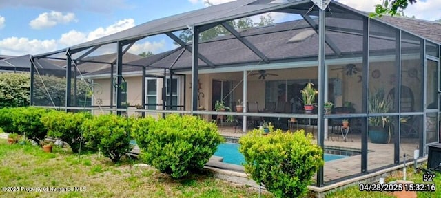 back of property featuring an outdoor pool, a lanai, ceiling fan, and a patio area