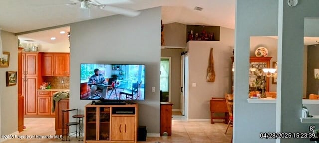 living area featuring light tile patterned floors, ceiling fan, and visible vents
