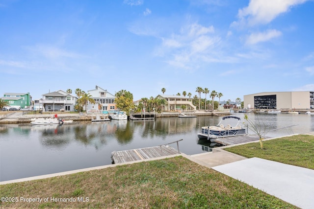 dock area featuring a water view and a yard