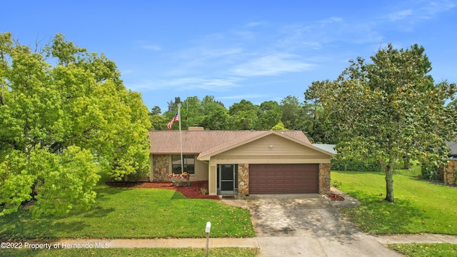 single story home featuring a garage and a front lawn