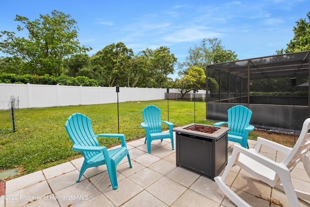 view of patio / terrace with glass enclosure and an outdoor fire pit