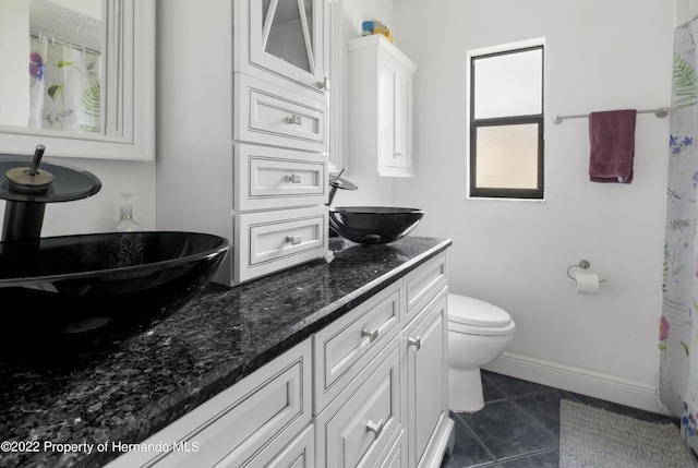 bathroom featuring tile patterned floors, toilet, and vanity
