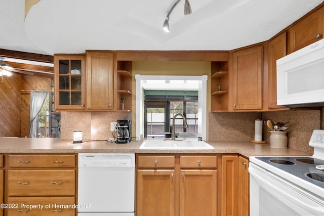 kitchen with sink, white appliances, ceiling fan, and backsplash