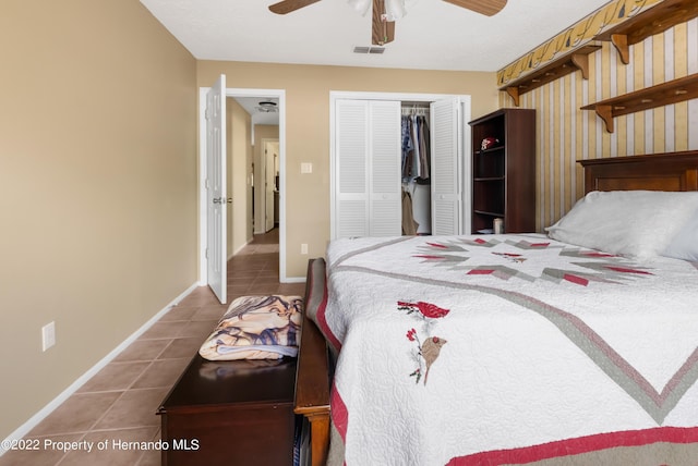 bedroom featuring tile patterned floors, ceiling fan, and a closet