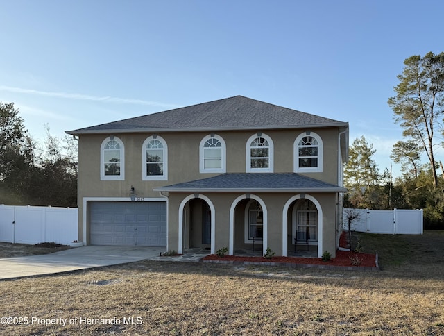 front of property with a porch, a garage, and a front yard