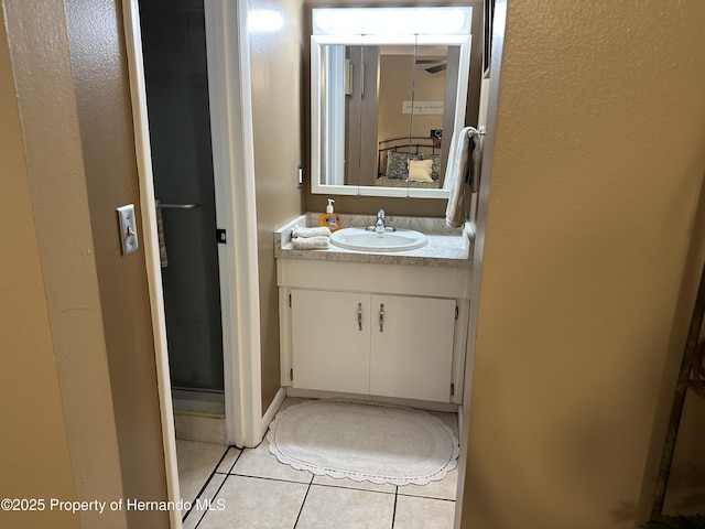 bathroom featuring vanity, an enclosed shower, and tile patterned flooring