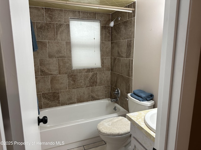 full bathroom featuring tiled shower / bath, vanity, and toilet