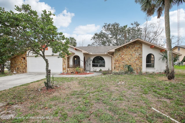 view of front facade with driveway, a garage, stone siding, a front lawn, and stucco siding