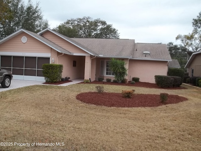 ranch-style home with a garage and a front yard