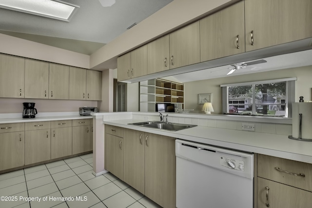 kitchen featuring sink, ceiling fan, white dishwasher, light tile patterned flooring, and light brown cabinetry