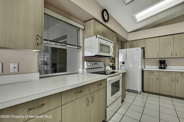 kitchen featuring light tile patterned flooring, white appliances, lofted ceiling, and light brown cabinets