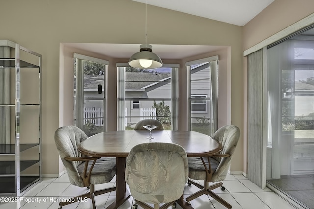 dining room featuring lofted ceiling and light tile patterned floors