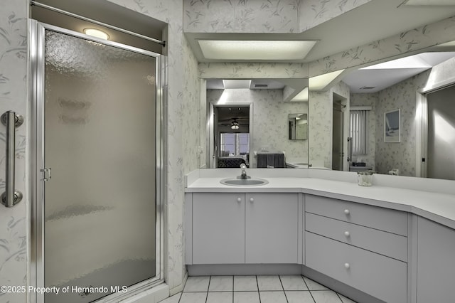 bathroom featuring walk in shower, vanity, and tile patterned flooring