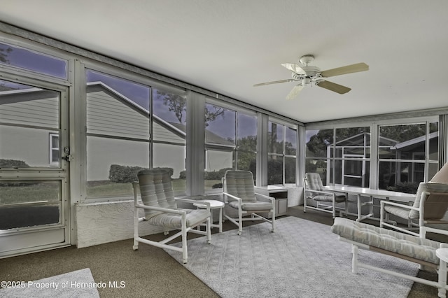 sunroom featuring ceiling fan