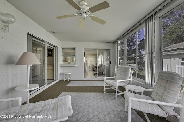 sunroom / solarium with ceiling fan