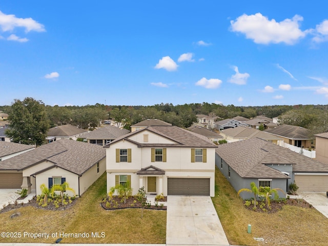 front of property featuring a garage and a front lawn