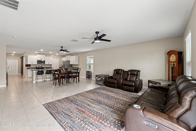 living room with light tile patterned floors and ceiling fan