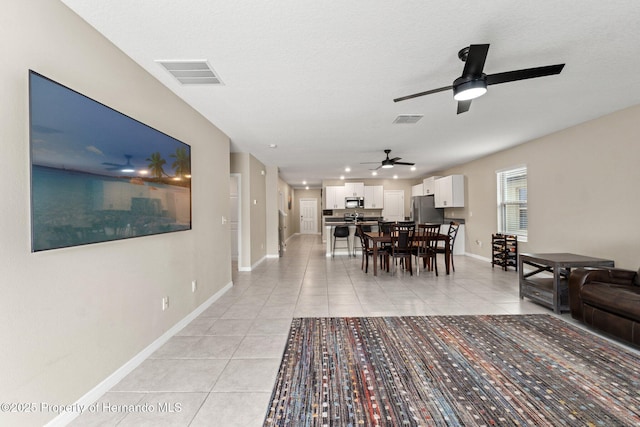 dining space with light tile patterned floors and a textured ceiling