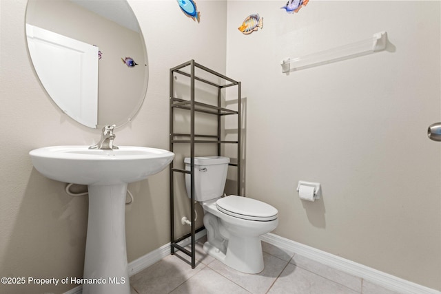 bathroom featuring tile patterned flooring and toilet