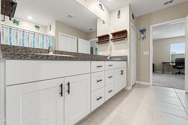 bathroom featuring tile patterned flooring and vanity