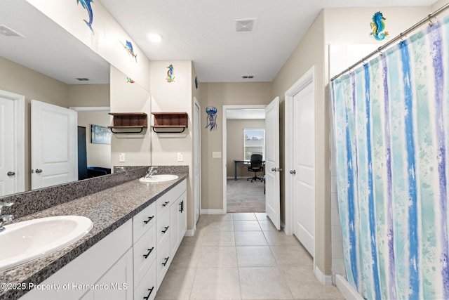 bathroom with a shower with curtain, vanity, and tile patterned flooring