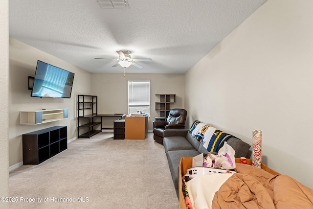 living room featuring a textured ceiling, light colored carpet, and ceiling fan