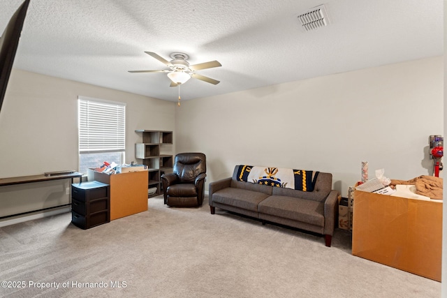 interior space with a textured ceiling and ceiling fan