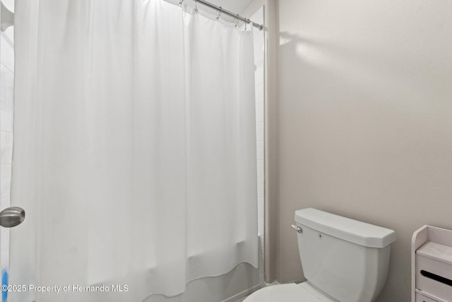 bathroom with toilet and walk in shower