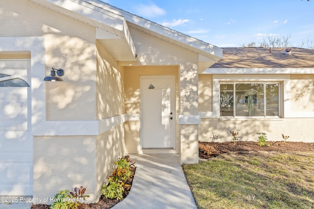 entrance to property with a lawn