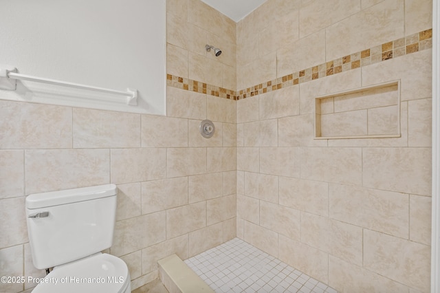 bathroom with toilet, tile walls, and a tile shower