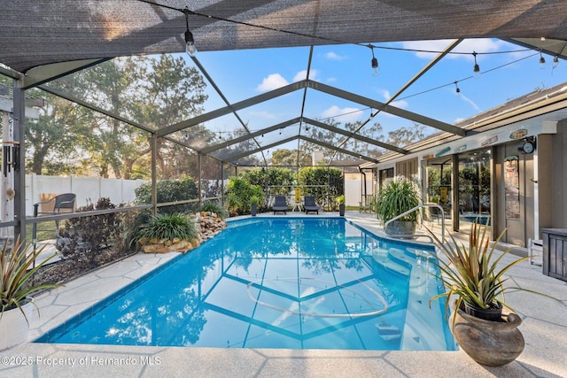 view of swimming pool with a patio area and glass enclosure