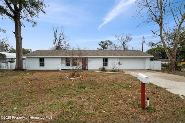 single story home featuring a garage and a front yard