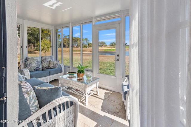 sunroom / solarium with a water view