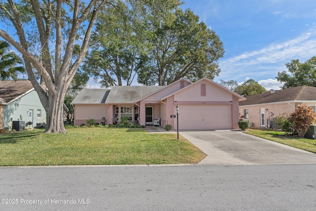 single story home with central AC, a garage, and a front lawn