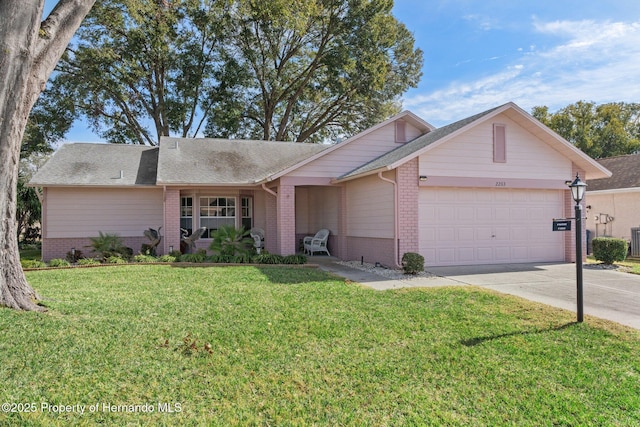 single story home featuring a garage, a porch, and a front yard