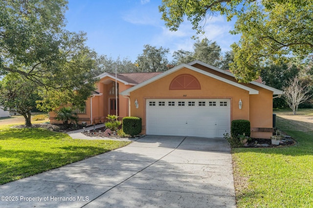 view of front of house featuring a garage, a front yard, concrete driveway, and stucco siding