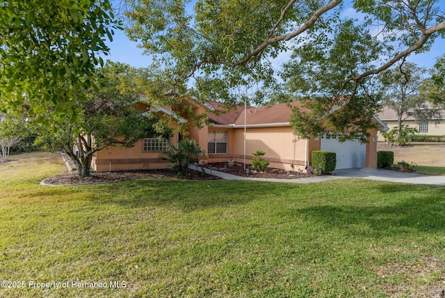 ranch-style home featuring a garage, a front yard, concrete driveway, and stucco siding