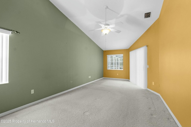 spare room with visible vents, light carpet, ceiling fan, high vaulted ceiling, and baseboards