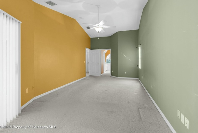 interior space featuring baseboards, visible vents, a ceiling fan, carpet flooring, and high vaulted ceiling