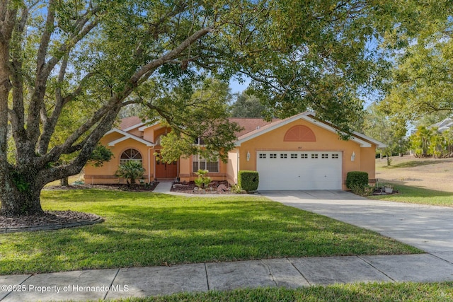 view of front of house with a garage, a front lawn, concrete driveway, and stucco siding