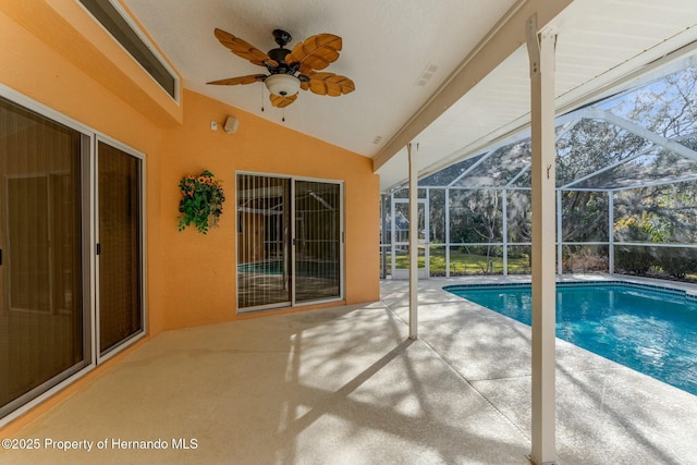 pool with ceiling fan, glass enclosure, and a patio area