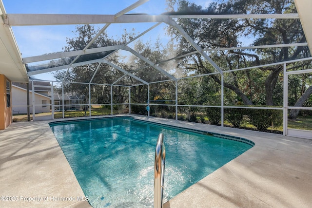 outdoor pool with glass enclosure and a patio