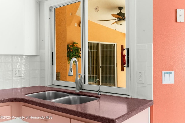 kitchen featuring tasteful backsplash, a sink, and ceiling fan