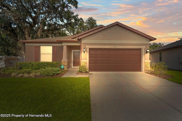 view of front of home with a yard and a garage