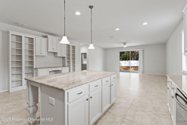 kitchen featuring white cabinetry, a center island, stainless steel dishwasher, pendant lighting, and light stone countertops