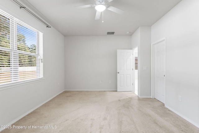 carpeted empty room with ceiling fan